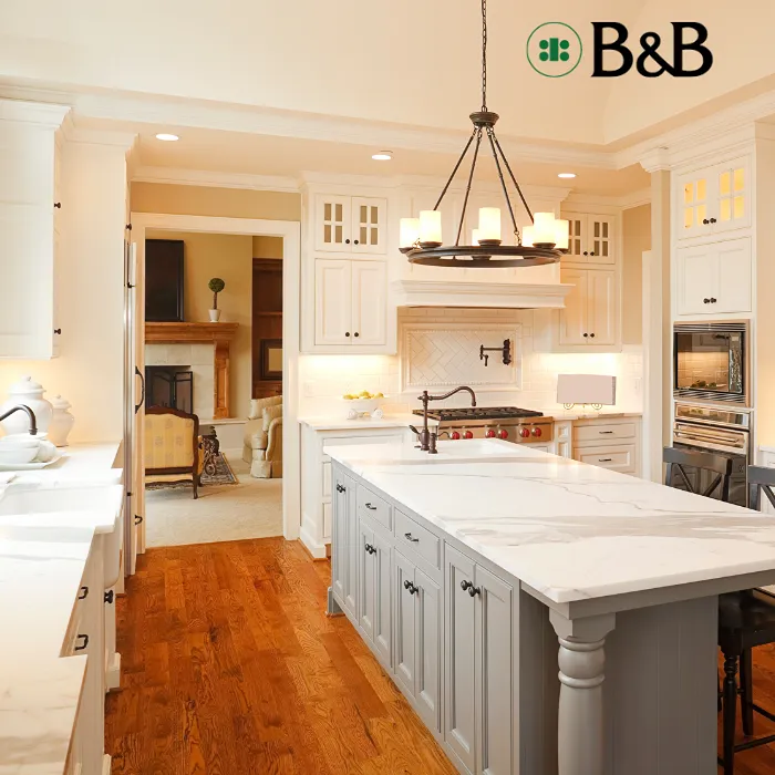 Kitchen with white cabinets and countertops with wooden flooring;.